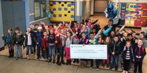 Prairie Mountain group of students holding a check from NW Community Credit Union