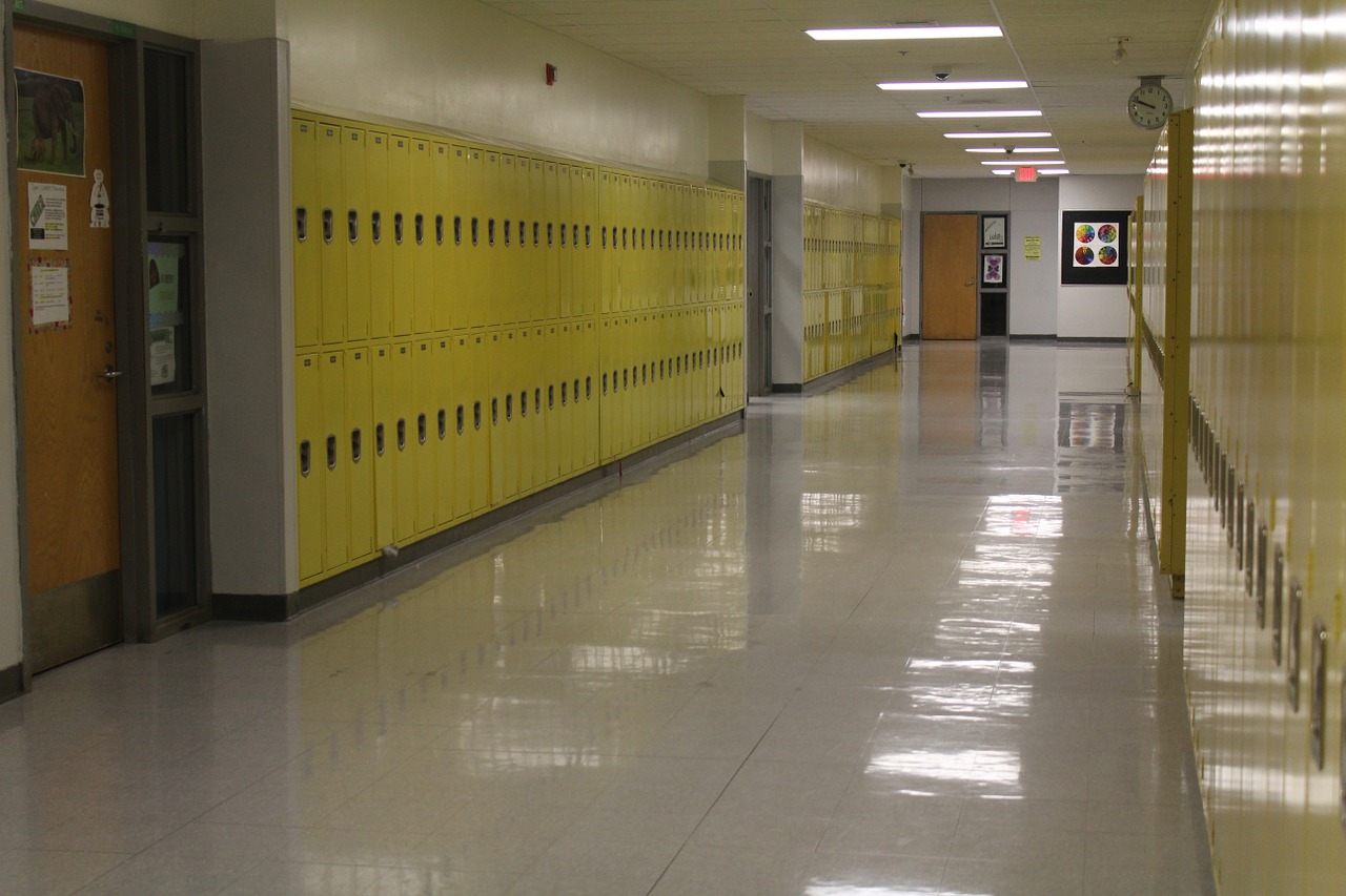 empty school hallway with yellow lockers