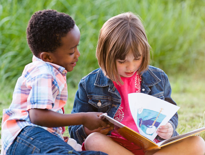 a boy and a girl reading a book