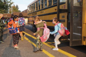 Students getting off the bus at Irving elementary