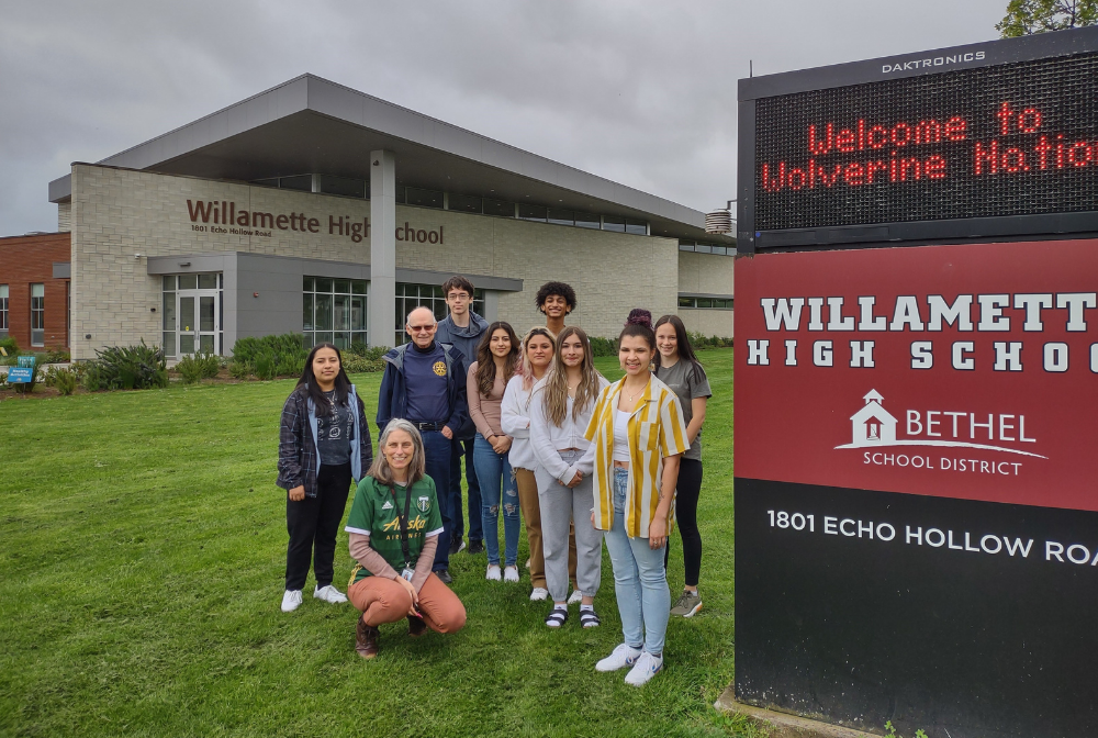 a group of students standing next to the electronic sign at Willamette High School