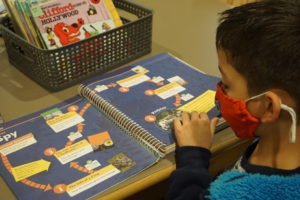 students looking at language arts materials